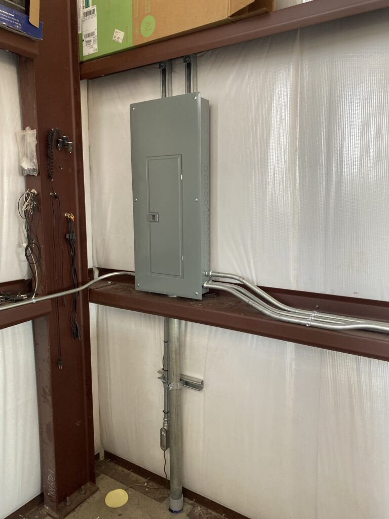 Electrical panel and conduit in a steel building